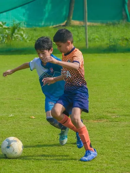 A duel for possession, showing the healthy competition and sportsmanship I encourage in all my tournaments.