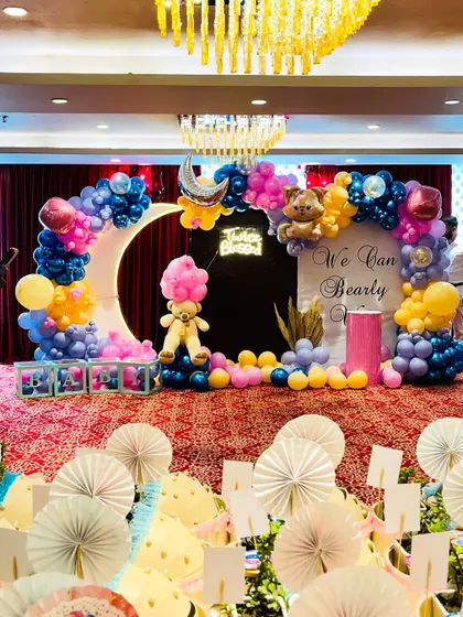 We love bringing adorable themes to life for baby showers. This "We Can Bearly Wait" setup for twins features a large crescent moon prop with an integrated balloon arch, teddy bear accents, a custom "Twice Blessed" neon sign, and a soft pastel color palette.