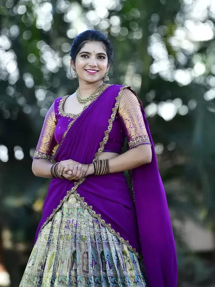 Dr. Nikitha looks stunning in this purple and gold langa voni. We converted a beautiful Paithani silk saree to create this regal look for her.
