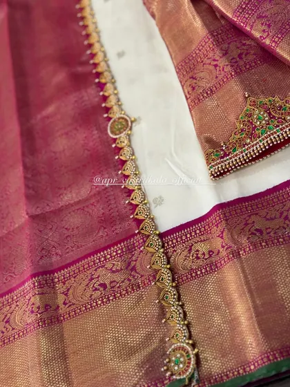 A detailed shot of the embroidered waist belt and sleeve cuff, designed to match the necklace pattern on the blouse.