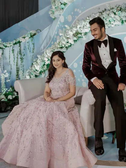 A beautiful stage shot of the couple. The soft makeup and hairstyle perfectly complement the fairytale vibe of her engagement look.