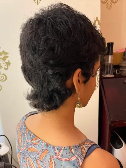 The back view of the curly mullet, highlighting the unique shape of the cut.