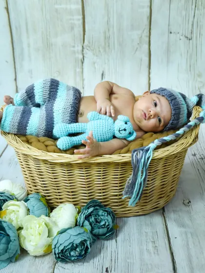 This little guy is looking so cute and alert in his knitted outfit. We have a variety of handmade props and outfits for our newborn sessions.