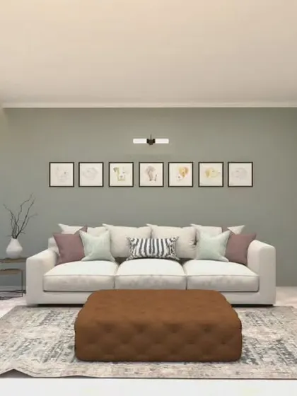 A clean and contemporary living room with a soothing color palette. The soft green accent wall, combined with a neutral sofa and simple gallery wall, creates a light and airy feel. The large plant adds a touch of life and freshness.