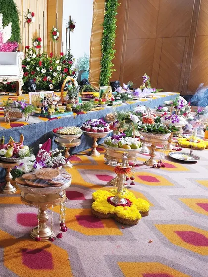 A side view of a full ceremonial display table. This photo highlights the different levels and types of trays I use, from fruit platters to floral arrangements, creating a visually interesting and grand setup.