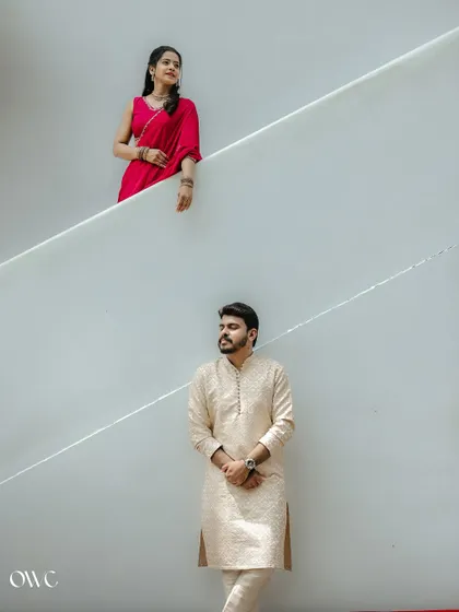 A minimalist composition with the couple separated by the clean lines of a staircase, creating a modern and artistic feel.