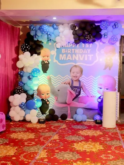 Here is another take on the Boss Baby theme, set up for a first birthday at home. I used character standees, a balloon garland, and a custom backdrop to create a dedicated photo corner.