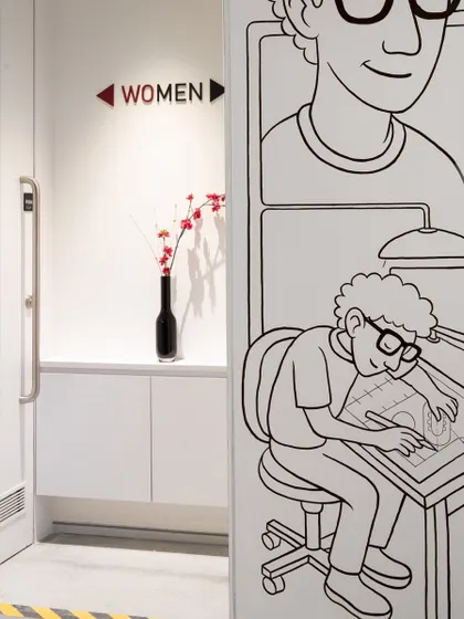 Even our restroom signage gets a creative touch. A small detail from our office that shows our playful approach to design.