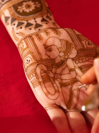 The process of creating a custom bride portrait. Every line is carefully drawn to capture the likeness and grace of the bride, turning her hand into a canvas for her own story.