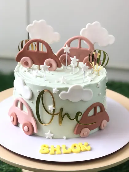 A stylish and modern car-themed cake for a first birthday, with a pastel color palette and clean lines.