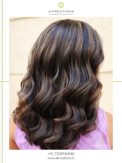 Soft brown highlights that create a natural, beautiful look, styled into gentle waves for a touch of elegance.