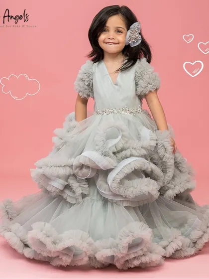 The Luna Grey gown is all about dramatic texture, with layers of structured and soft ruffles creating incredible volume.