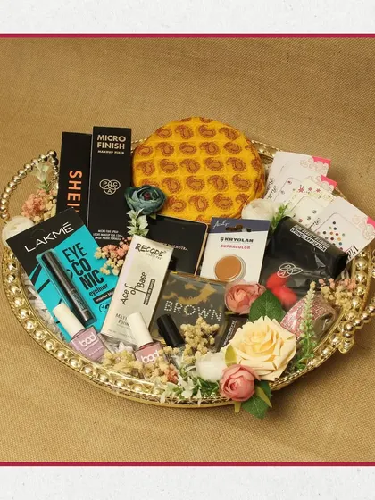 A makeup lover's dream on a platter. This hamper is curated with popular products from brands like Lakme and Maybelline, along with other beauty essentials, all arranged on a decorative golden tray.