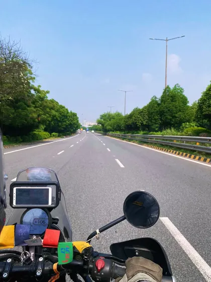 The view from my Royal Enfield Himalayan on an open highway. For me, the journey itself is the destination, and biking is a core part of my travel philosophy.
