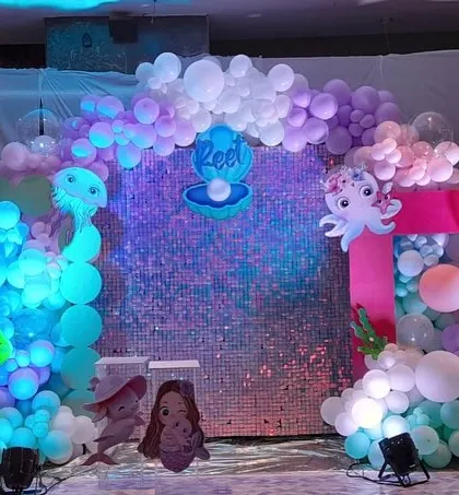 A slightly different view of the underwater baby welcoming setup, showing the iridescent quality of the sequin backdrop that mimics sparkling water.