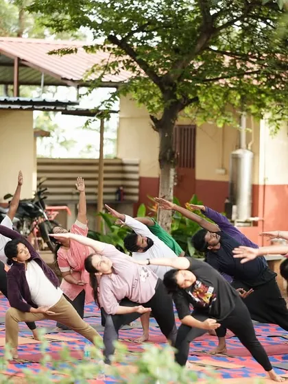 Guiding participants through a side-bending asana to open up the body.