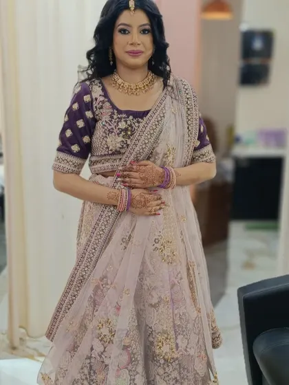 A full-length view of a client ready for an engagement ceremony. We provide complete styling, including makeup, hair, and ensuring the dupatta is draped perfectly to complete the traditional lehenga look.