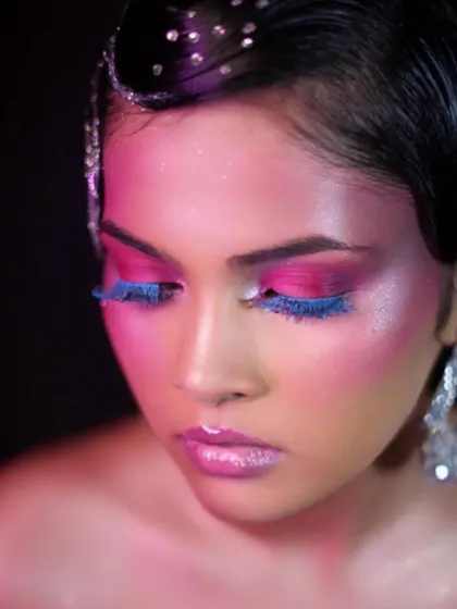 An artistic masterclass creation featuring vibrant pink and blue tones with feathered lashes. This look demonstrates advanced color blending and creative application.