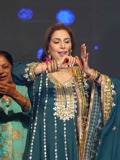 A beautiful moment of a family member performing a traditional dance step. We teach graceful hand gestures and expressions to make every performance authentic.