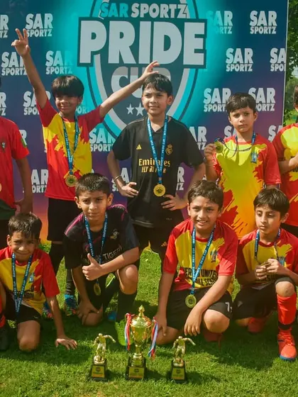 Posing for the camera with their championship trophy and individual awards.