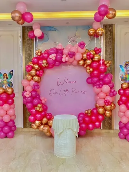 A full view of the "Welcome Our Little Princess" decoration in a well-lit home. The pink and gold balloon arrangement looks vibrant and is perfect for capturing beautiful family photos.