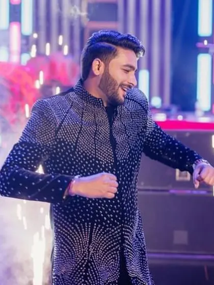 The groom looking sharp and confident during his sangeet performance. I help grooms feel comfortable on stage so they can enjoy their moment.