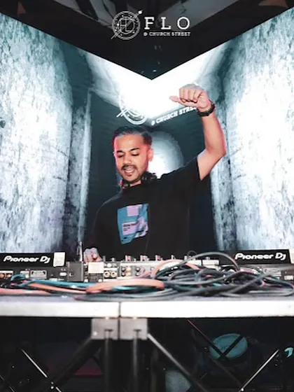 In front of a massive LED screen at Flo Church Street, with my hand up, feeling the beat.