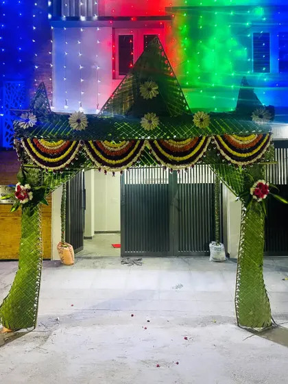 A chapra decorated for an evening event, with colorful lights illuminating the structure. The combination of traditional materials and modern lighting creates a festive mood.