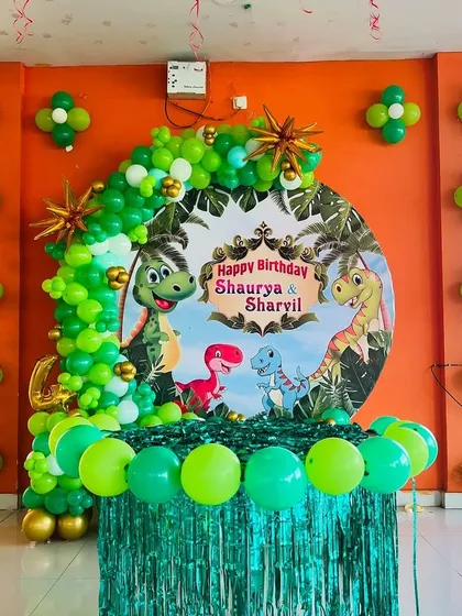 We bring kids' party themes to life with vibrant, detailed decorations. This jungle-themed birthday features a custom dinosaur backdrop, a lush green balloon arch, and matching balloon clusters to create an exciting atmosphere for the little ones.