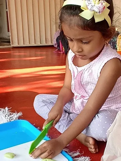 Making a healthy and delicious chickpea salad, where children practiced chopping vegetables and mixing ingredients to create a nutritious meal.