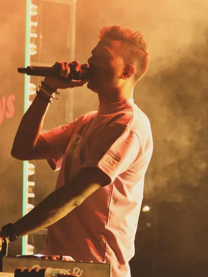 A close-up shot of me on the mic during the Mount Carmel College fest, lost in the music and the moment.