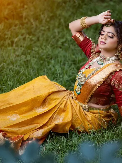 A Muhurtham look we created for a student demonstration. This yellow silk saree is paired with a contrasting red puff-sleeve blouse, adorned with traditional embroidery.