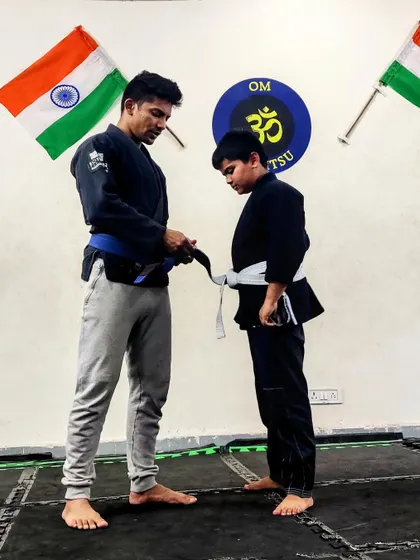 The formal moment of a BJJ promotion. Tying the stripe on a student's belt signifies a new level of understanding and responsibility in their martial arts journey.