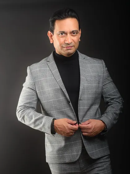 A confident and direct portrait. The simple pose and styling make this a strong, no-nonsense headshot that communicates capability.