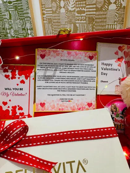 A close-up of the heartfelt letter and 'Will you be my Valentine?' card, making the gift deeply personal.