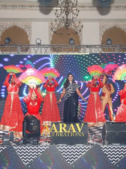 A colorful family performance using multi-colored fans as props. This adds a beautiful wave of color and movement to the stage, enhancing the visual appeal of the dance.