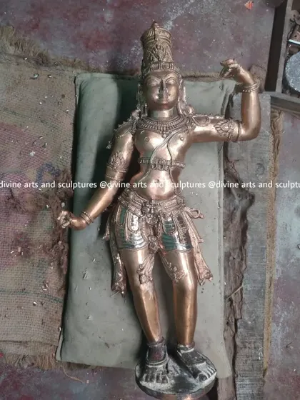 A sculpture from a Ramar set is seen here during the finishing process. Lying on a cushion to protect its details, the bronze is being chased and filed to smooth the surface and sharpen the lines.