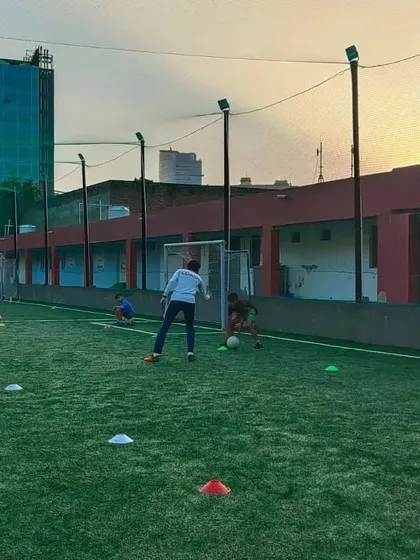 Young players enjoying a dribbling exercise at our free camp. We create a positive environment where kids can have fun while learning the basics of football.