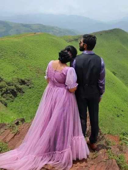 A view from the back of the couple enjoying the mountain scenery. The sheer puff sleeves of the lavender gown are a delicate detail.