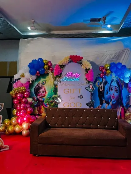 A wide angle view of the baby shower stage, showing how the different elements like character cutouts and the main backdrop come together to create a cohesive look.