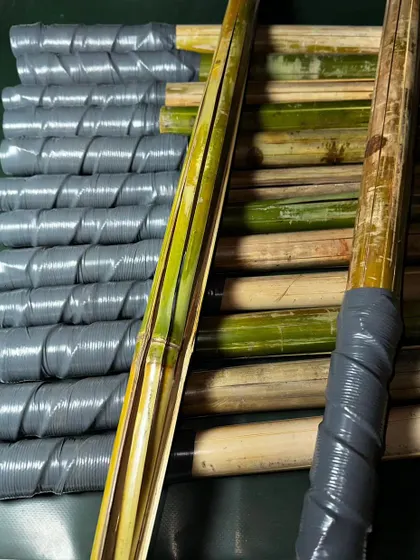 A close-up of the bamboo and the wrapped handles. You can see the natural material and the handcrafted quality of the finished product.
