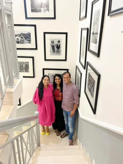 Posing with my wonderful clients on their beautiful staircase, surrounded by a gallery wall of their family memories.