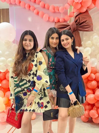 A group of stylish guests enjoying the bow-themed celebration.