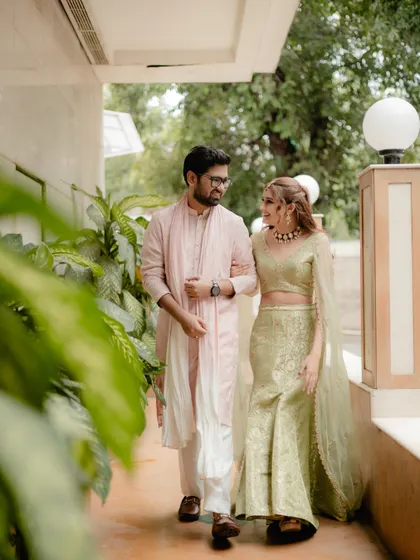 A candid moment of a couple walking together during their Mehndi celebrations. The soft light and natural interaction make this a quiet, beautiful portrait.