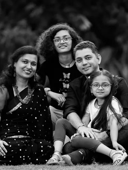 A family portrait converted to black and white, emphasizing the composition and the connection between the family members.