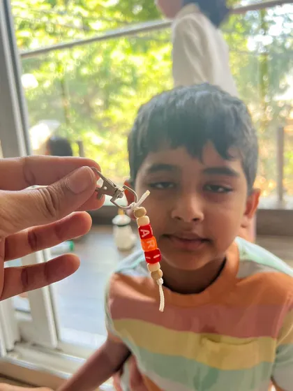 This little guy is showing off the keychain he made with his name on it. These make for wonderful, personal keepsakes.