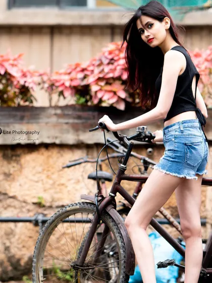 A rustic bicycle and a textured wall add a vintage, old-Bangalore charm to this modern street style photo.