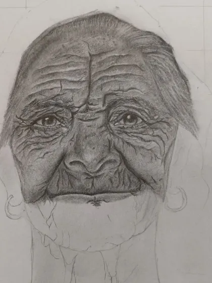 Here, the portrait is further along. You can see more definition in the eyes and forehead as the shading becomes more complex, showing the patient process of developing a realistic drawing.