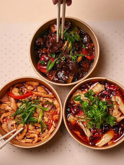 Three bowls, endless flavor. This is a typical setup for a small gathering, featuring Shredded Chicken, Kung Pao Chicken, and a spicy fish dish. There's something for everyone.