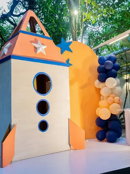 A custom-built rocket ship playhouse, providing a fun and interactive element for the kids at the space party.
